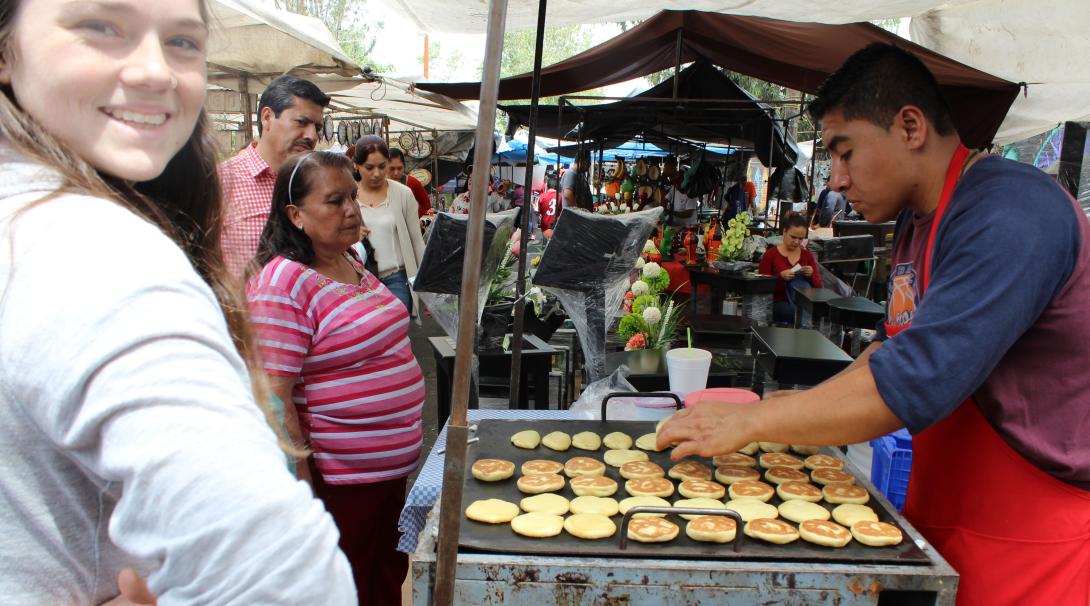 A projects Abroad volunteer ordering food from a street market in Mexico A volunteer walking around the street markets in Mexico and ordering food to get more familiar with the language